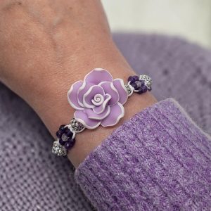 Geknoopte armband met een paars-witte fimoklei bloem, amethist, regenboogmaansteen bloemetjes en witte rhinestone kralen.
